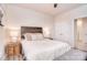 Well-lit bedroom with a rustic wooden headboard, plush bedding, and neutral decor at 124 Doncaster Dr, Mooresville, NC 28115