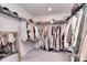 Walk-in closet with a variety of clothing hanging on rods and organized on shelves at 124 Doncaster Dr, Mooresville, NC 28115