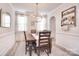 Formal dining room boasts natural lighting, modern chandelier, and decorative wall trim at 124 Doncaster Dr, Mooresville, NC 28115