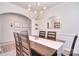 Formal dining room boasts natural lighting, modern chandelier, and decorative wall trim at 124 Doncaster Dr, Mooresville, NC 28115