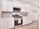 This modern kitchen is fitted with stainless steel appliances and ample storage in the white cabinets at 124 Doncaster Dr, Mooresville, NC 28115