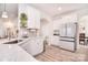 A bright, modern kitchen with white cabinets, an island, and stainless steel appliances at 124 Doncaster Dr, Mooresville, NC 28115