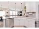 A modern, open-concept kitchen features an island, stainless steel appliances, and seamless access to the living area at 124 Doncaster Dr, Mooresville, NC 28115