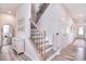 Elegant staircase featuring wood and wrought iron detailing, leading to the upper level at 124 Doncaster Dr, Mooresville, NC 28115