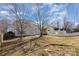 A large backyard with a house, trees, and an ample lawn area at 132 Elizabeth Hearth Rd, Mooresville, NC 28115