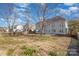 Expansive backyard featuring a well-maintained lawn, mature trees, and a spacious patio at 132 Elizabeth Hearth Rd, Mooresville, NC 28115