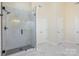 Modern bathroom with a glass-enclosed shower and stylish marble tile at 132 Elizabeth Hearth Rd, Mooresville, NC 28115