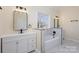 Elegant bathroom featuring a soaking tub, dual sinks, and marble accents at 132 Elizabeth Hearth Rd, Mooresville, NC 28115