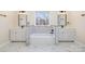Elegant bathroom featuring a soaking tub, dual sinks, and marble accents at 132 Elizabeth Hearth Rd, Mooresville, NC 28115