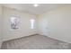 Neutral bedroom featuring a large window and neutral carpet at 132 Elizabeth Hearth Rd, Mooresville, NC 28115