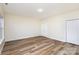 Spacious bedroom features neutral paint, light wood floors, and a closet at 132 Elizabeth Hearth Rd, Mooresville, NC 28115