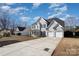 Charming two-story home with a three car garage and long driveway set in a lush landscape at 132 Elizabeth Hearth Rd, Mooresville, NC 28115