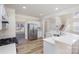 Open kitchen layout with stainless steel refrigerator, granite counters, and views to the breakfast room at 132 Elizabeth Hearth Rd, Mooresville, NC 28115