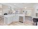 Bright modern kitchen boasts stainless dishwasher, white cabinets, and a large island at 132 Elizabeth Hearth Rd, Mooresville, NC 28115