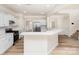 Modern open kitchen with white cabinets, granite countertops, and stainless steel appliances at 132 Elizabeth Hearth Rd, Mooresville, NC 28115