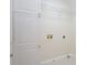 Functional laundry room with white cabinets, shelving, and utility connections at 132 Elizabeth Hearth Rd, Mooresville, NC 28115