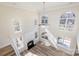 Bright living room with high ceilings, large windows, and a cozy fireplace at 132 Elizabeth Hearth Rd, Mooresville, NC 28115