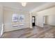 Open living room with hardwood floors and neutral paint, adjacent to the entry foyer at 132 Elizabeth Hearth Rd, Mooresville, NC 28115