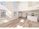 Bright, open living space with soaring ceilings, light wood floors and an open concept to the kitchen at 132 Elizabeth Hearth Rd, Mooresville, NC 28115
