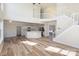 Open-concept living space with staircase, kitchen with island and hardwood floors at 132 Elizabeth Hearth Rd, Mooresville, NC 28115