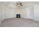 Spacious main bedroom with a tray ceiling, fireplace, and neutral carpet at 132 Elizabeth Hearth Rd, Mooresville, NC 28115