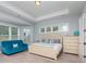 Main bedroom with a plush teal sofa and a calm color scheme at 1320 Torrens Dr, Wesley Chapel, NC 28110