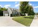 Gray house with stone accents, two-car garage, and a manicured lawn at 1320 Torrens Dr, Wesley Chapel, NC 28110