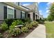 Landscaped walkway to the front door with stone and flowers at 1320 Torrens Dr, Wesley Chapel, NC 28110