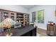 Home office features built-in shelving and a large desk at 1320 Torrens Dr, Wesley Chapel, NC 28110