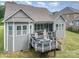 Gray house with large deck and backyard, offering outdoor entertaining space at 1320 Torrens Dr, Wesley Chapel, NC 28110