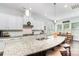 Large kitchen island with granite countertops and white cabinetry at 1320 Torrens Dr, Wesley Chapel, NC 28110