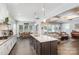 Open concept kitchen with island, hardwood floors, and white cabinets at 1320 Torrens Dr, Wesley Chapel, NC 28110