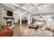 Open living room with stone fireplace, hardwood floors, and kitchen view at 1320 Torrens Dr, Wesley Chapel, NC 28110