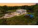 Expansive property featuring a modern home, playground, and meticulously maintained landscaping, providing a luxurious outdoor lifestyle at 15700 Youngblood Rd, Charlotte, NC 28278