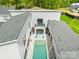 Modern home with private pool and stylish patio area, designed for luxurious outdoor living and relaxation at 15700 Youngblood Rd, Charlotte, NC 28278