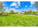 Lush green backyard with ample space for recreation, featuring a playground set and open field at 15700 Youngblood Rd, Charlotte, NC 28278
