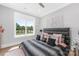 Cozy bedroom with a large window providing natural light and backyard view at 15700 Youngblood Rd, Charlotte, NC 28278