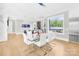Bright and airy dining room featuring a glass table, modern white chairs, and large windows offering abundant natural light at 15700 Youngblood Rd, Charlotte, NC 28278