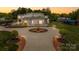 Stunning home with circular driveway, lush landscaping, and modern design creating a grand and inviting curb appeal at 15700 Youngblood Rd, Charlotte, NC 28278