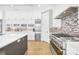 Gourmet kitchen with stainless steel appliances, custom cabinets, and tile backsplash at 15700 Youngblood Rd, Charlotte, NC 28278