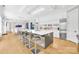 Elegant white kitchen with stainless steel appliances, expansive island, and breakfast bar at 15700 Youngblood Rd, Charlotte, NC 28278
