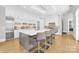 Elegant white kitchen featuring stainless steel appliances, a large island, and seating at 15700 Youngblood Rd, Charlotte, NC 28278