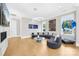 Bright living room with unique circular couch, aquarium, fireplace, and modern art at 15700 Youngblood Rd, Charlotte, NC 28278