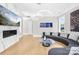 Bright living room with unique circular couch, aquarium, fireplace, and modern art at 15700 Youngblood Rd, Charlotte, NC 28278