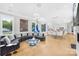 Open-concept living area with large windows, modern furnishings, and a seamless dining space at 15700 Youngblood Rd, Charlotte, NC 28278