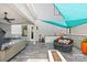 Stylish outdoor patio featuring a hot tub, seating, and built-in kitchenette at 15700 Youngblood Rd, Charlotte, NC 28278