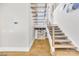 Modern staircase with sleek design, featuring wood and metal accents and an open concept layout at 15700 Youngblood Rd, Charlotte, NC 28278