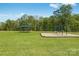 Community common area showing picnic shelter and swing set in an open green space under a clear blue sky at 1715 Wooten Way, Bessemer City, NC 28016