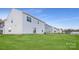 Home's exterior showcases a clean design and grassy backyard at 1715 Wooten Way, Bessemer City, NC 28016