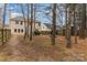 Wide backyard with a long fence for privacy, tall trees, and a view of the back of the house at 3302 Cole Mill Rd, Charlotte, NC 28270